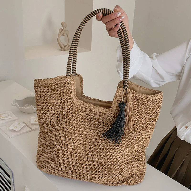 Borsa da spiaggia estiva in paglia intrecciata con nappe